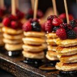 Mini pancake stacks on skewers with berries and syrup. What size is a mini pancake?