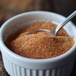 Cinnamon and sugar being mixed in a white bowl How do you keep cinnamon from clumping in French toast?